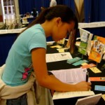 Jordon Reyes, juvenile author, signing a book at Book and Author Festival, 2009